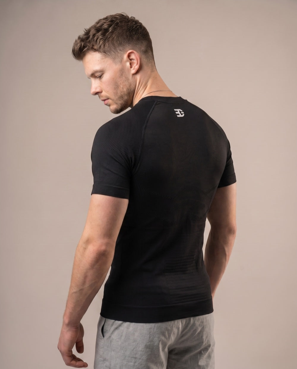 Black textured compression shirt — back logo