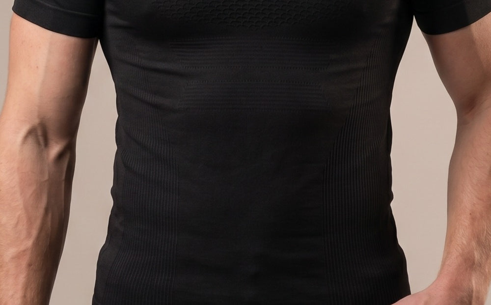 Black textured compression shirt — body-mapped texture zones close-up